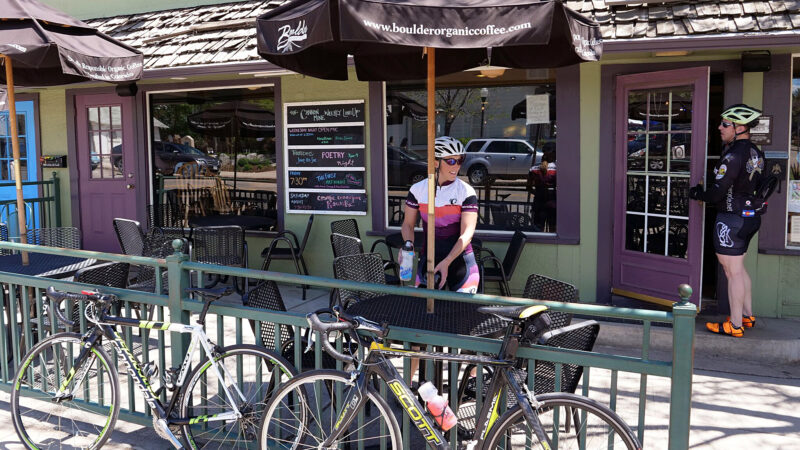 Two cyclists visit a coffee shop in Lafayette, Colorado, the small town that where Cannon Trail was built; a good example of small town residential infill. 