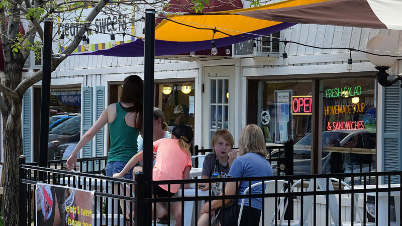 A family dines alfresco at a cafe in Old Town Lafayette, near Cannon Trail, which was built on an infill parcel.
